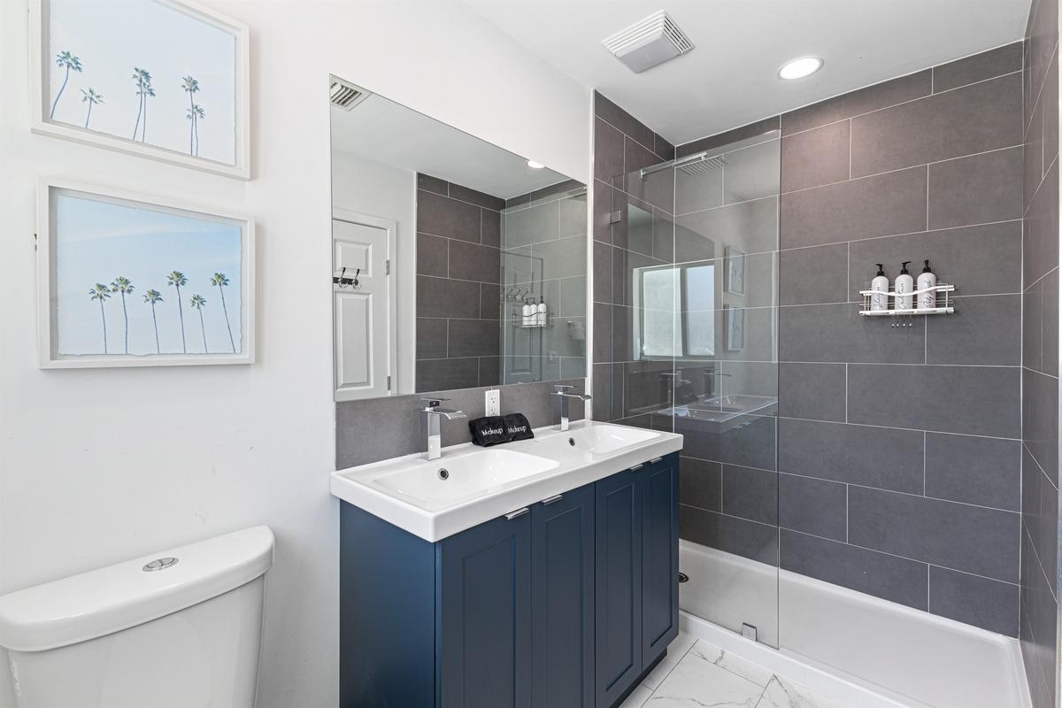 Ensuite spa bathroom with modern finishes for bedroom 1.