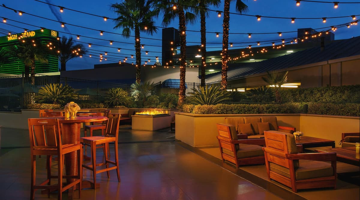 Relax under the Vegas stars with cozy outdoor seating and glowing string lights. ✨🌴