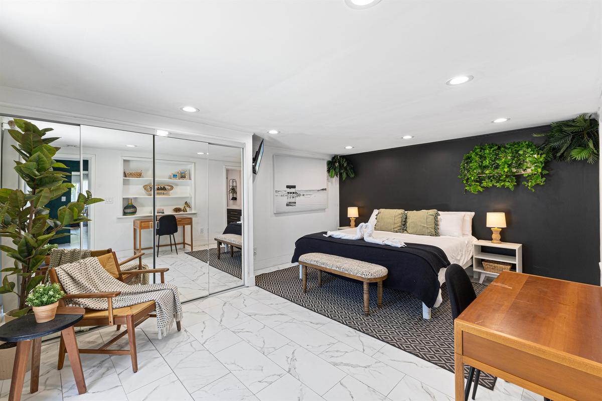 Primary bedroom — private backyard access and cozy work desk.