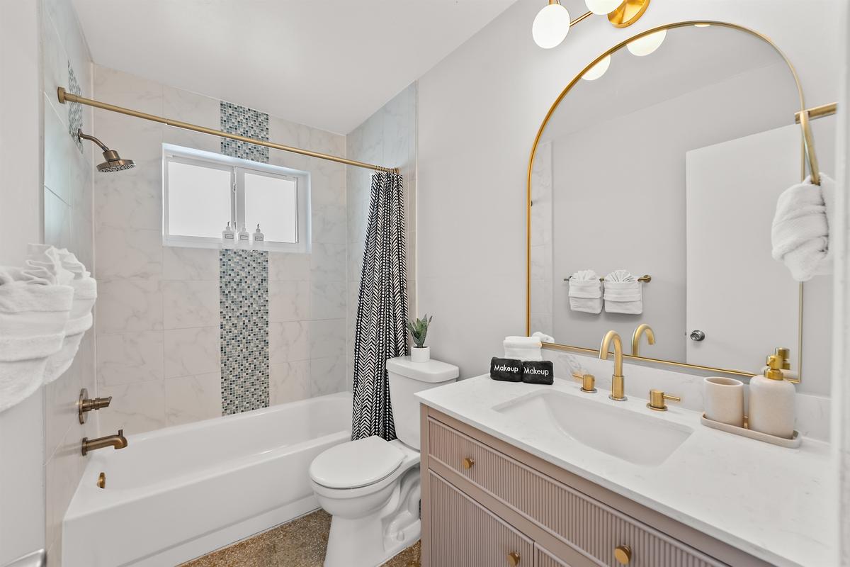 🛁 Start your mornings sparkling in this bright, glam bathroom shared by the hallways bedrooms.